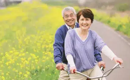 Caregiver riding a cycle with senior