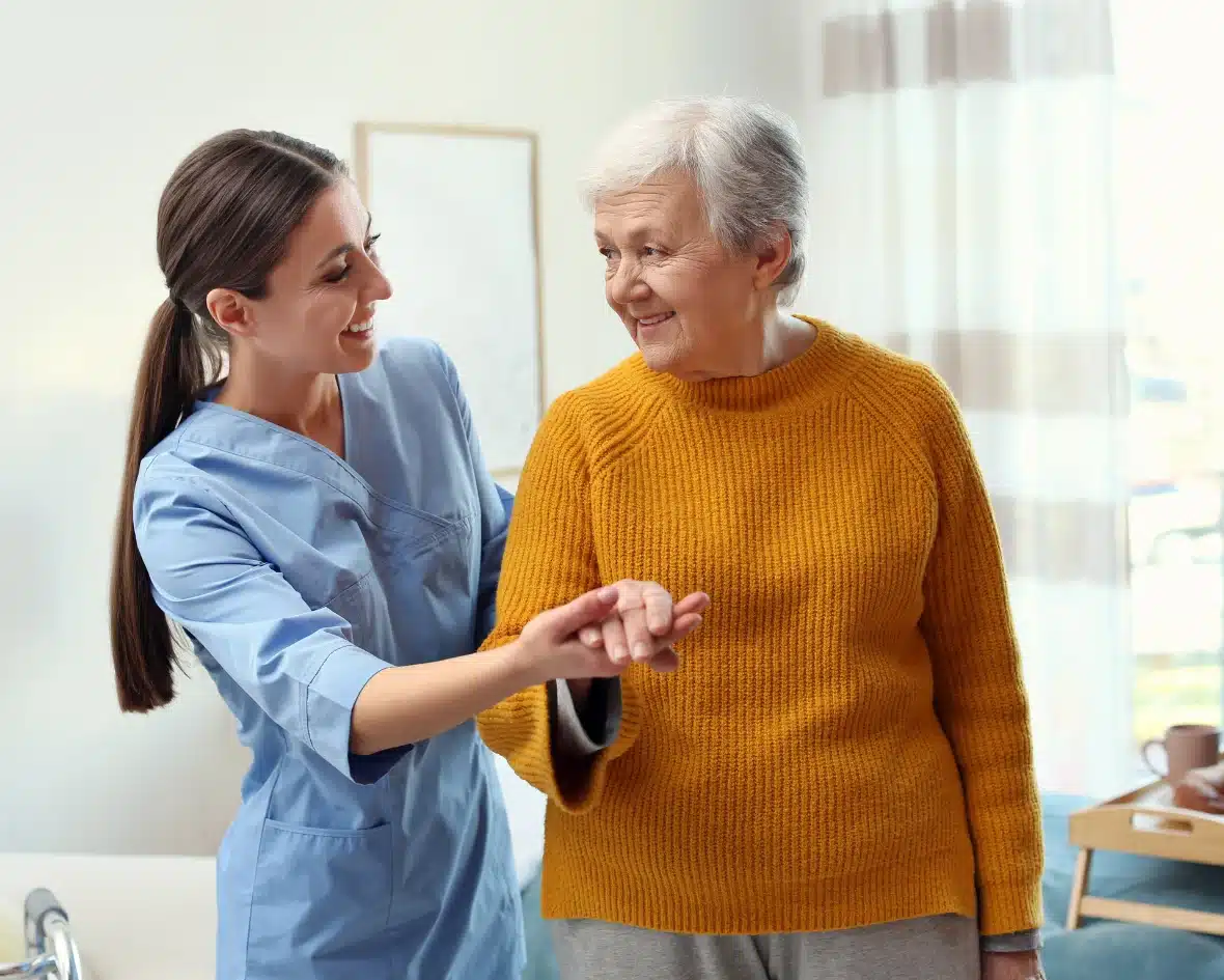 Caregiver holding senior women hand